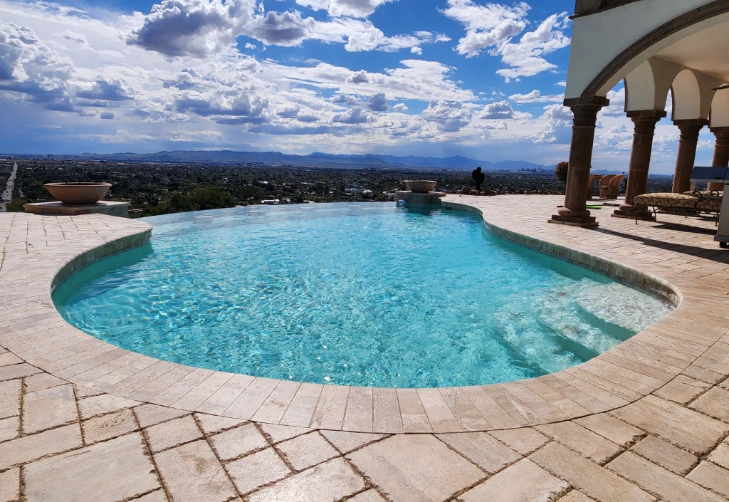 A pool with a view of the sky and clouds.