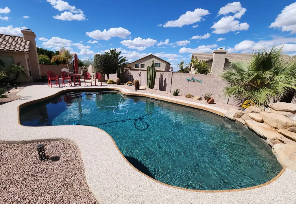 A pool with a blue water and a sky background