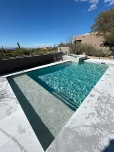 A pool that is in the middle of some kind of yard.