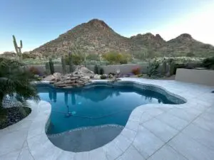 A pool with a mountain view in the background.