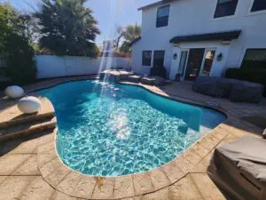 A pool with water falling into it.