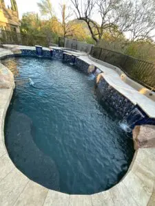 A pool with water running down the side of it.