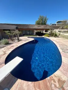 A pool with a large blue swimming pool in the middle of it.