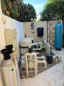 A backyard with many pipes and water tanks