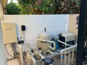 A pool pump and filter system in the backyard.