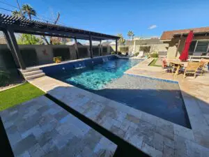 A pool with a bench and a table in the middle of it