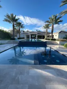 A pool with palm trees in the background