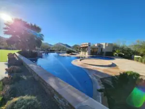 A pool with a large swimming area in the middle of it