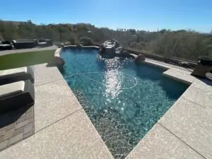 A pool with a large water fountain in the middle of it.