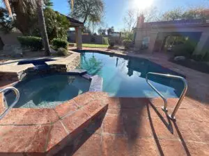 A pool with steps leading to the side of it.